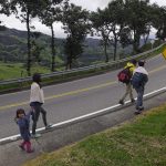 Migrantes venezolanos con máscaras faciales debido al brote de (COVID-19) caminan por una carretera en su viaje de regreso a Colombia después de que los sectores económicos fueron reactivados, cerca de la ciudad de Bucaramanga. REUTERS/Natalia Ortiz