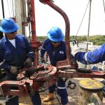 Empleados de una empresa petrolera trabajan junto a las tuberías de excavación de crudo en el campo Rubiales, en el departamento del Meta.REUTERS/José Miguel Gómez